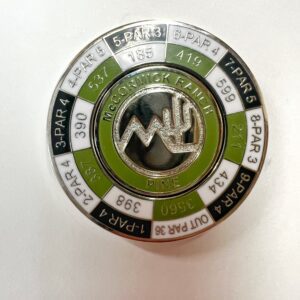 A green and white circular pin with the words " voluntaryism of life ".